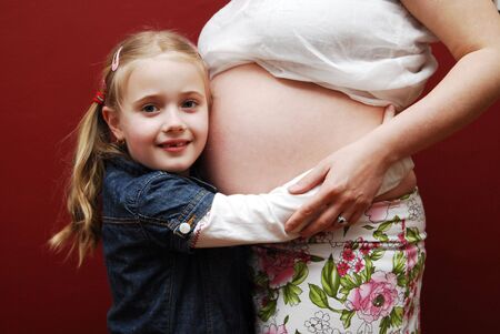 Girl with mother's bellyの写真素材