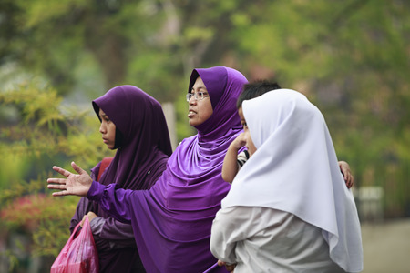 MALACCA, MALAYSIA - JUNE 22, 2013  Group of Muslim women on the street on June 22, 2013 in Malacca, Malaysia  Malacca is a historical city center has been listed as a UNESCO World Heritage Site のeditorial素材