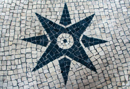 Clear stone blocks pavement texture with a dark central star motive for backgroundの写真素材