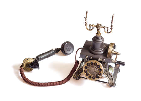 Decorated retro vintage metal telephone isolated on white backgroundの写真素材