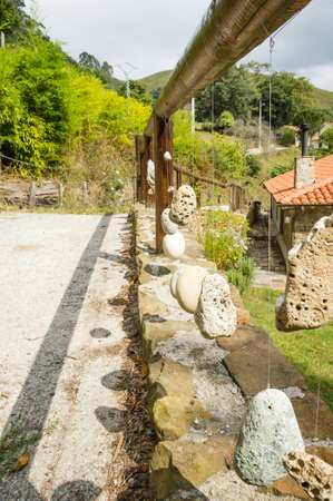 Natural wooden railing with decorative hanged stonesの写真素材