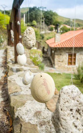 Natural wooden railing with decorative hanged stonesの写真素材
