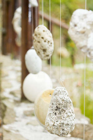 Natural wooden railing with decorative hanged stonesの写真素材