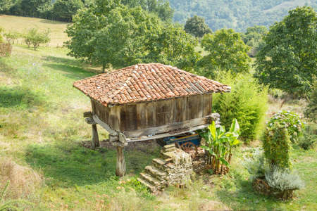 View of typical granary of Asturias, in Spain, raised by stone pillars and known as  horreo の写真素材