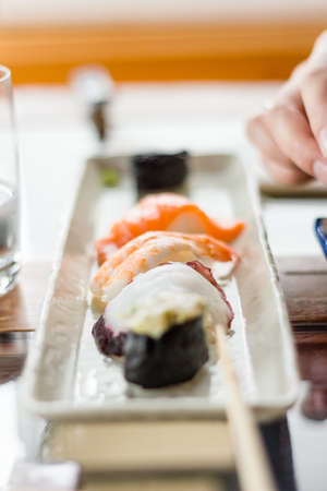 Closeup of delicious sushi set on large white plateの写真素材