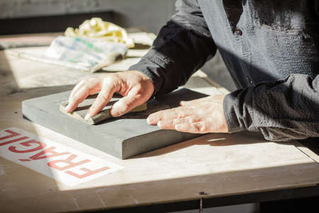 Painter artist working with hands on a oil canvas textureの写真素材