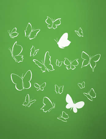 Group of white silhouettes butterflies flying over a green backgroundの写真素材