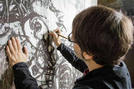 Painter artist working in a original oil canvas in the studyの写真素材