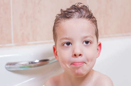 Cute boy happiness having bath in a bathtub