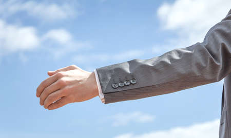 Closeup of business man showing his open hand ready for seal a deal
