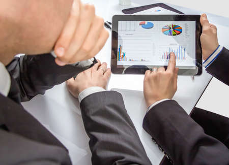 Business people analyzing financial charts and documents in a meeting for the success of companyの写真素材