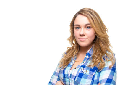 Portrait of beautiful blonde teenager student with blue plaid shirt posing の写真素材