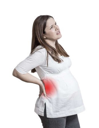 Pregnant woman with a strong pain massaging her back over white background