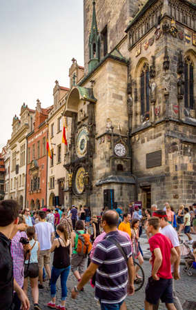 PRAGUE, CZECH REPUBLIC - JULY 16, 2014 Tourists walking in front of astronomical clock on Old Town...