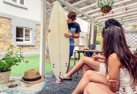 Couple of young beautiful women having fun in a summer surf class outdoors. Holidays leisure concept.の写真素材