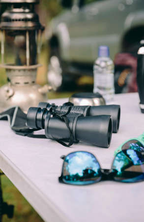 Close up of binoculars over camping table in a nature backgroundの写真素材