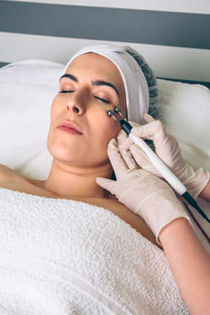 Woman getting rf lifting around of eyes in clinic