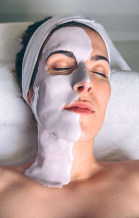 Woman lying with facial mask treatment in spaの写真素材