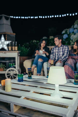 White lamp over pallets table in outdoors party
