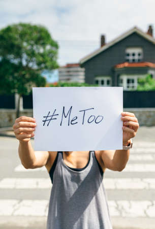 Unrecognizable young woman showing poster with metoo hashtagの写真素材