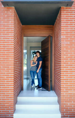 Happy couple at the entrance of their new house