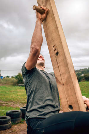 Male participant in a obstacle course doing pegboard obstacleの写真素材