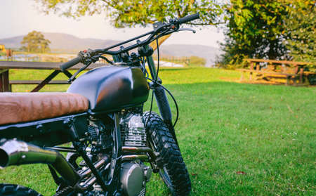 Beautiful vintage custom motorcycle parked on the grassの写真素材