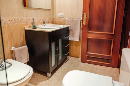 Interior of tidy bathroom with washbasin cabinet