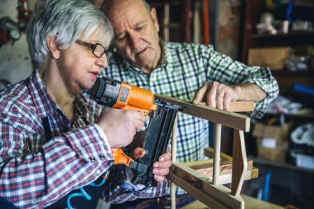 Senior couple working in a carpentry workshopの写真素材