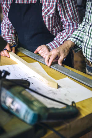 Unrecognizable senior couple working in a carpentry workshopの写真素材