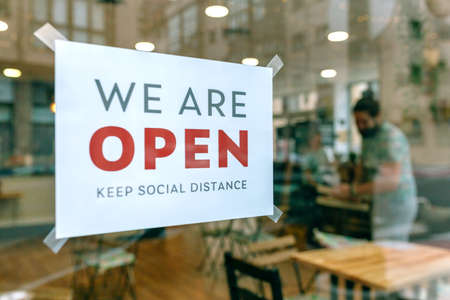 Commercial reopening poster after coronavirus with workers cleaning in the backgroundの写真素材