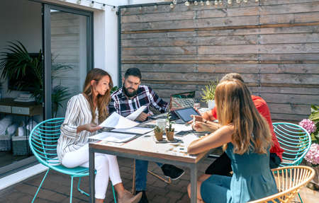 Group of people in a work meeting on the terrace of the office