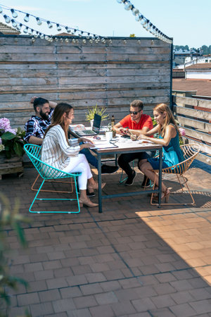 Group of people in a informal meeting on the attic terrace of the officeの写真素材
