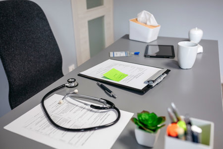 Doctor desk with medical documents and stethoscopeの写真素材