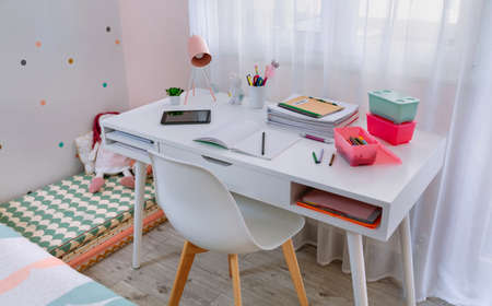 White desk in girls bedroom decorated in pastel colorsの写真素材