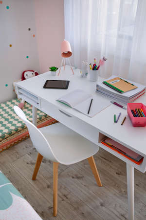 White desk in girls bedroom decorated in pastel colorsの写真素材