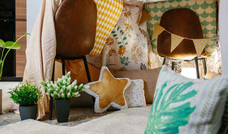 Interior of homemade tent made with chairs and bed sheets in the living room