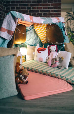 Makeshift kids tent made with chairs and bed sheets at homeの写真素材