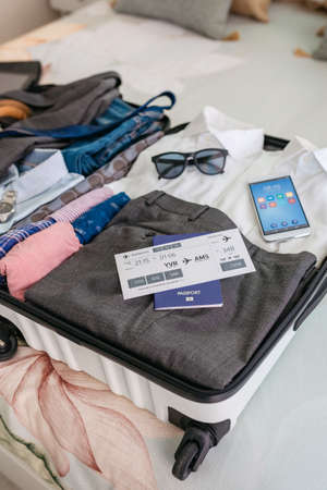 Businessman suitcase prepared for business trip with boarding passの写真素材