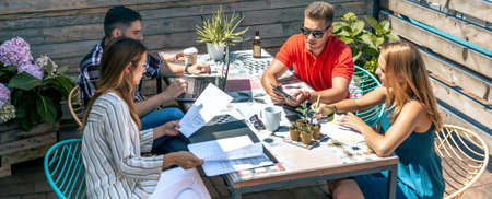 Group of people in a informal meeting on the terrace of the office