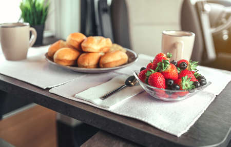 Closeup of fruit bowl in a healthy breakfast on the table. Selective focus on fruit bowl in foregroundの写真素材