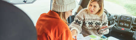 Women telecommuting during a camper van tripの写真素材