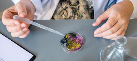 Banner of unrecognizable female scientist adding drop of liquid from from pipette over petri dish...