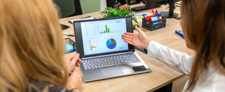 Banner of unrecognizable businesswomen collaborating efficiently, reviewing performance charts and...