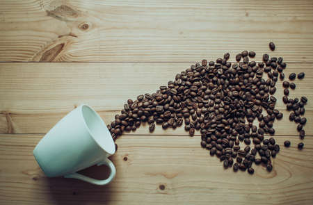 Splash out the coffee beans from a cup conceptの写真素材