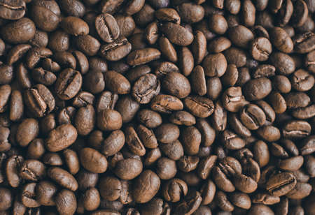 big brown coffee beans on the tableの写真素材