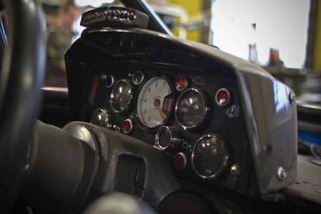 Speedometer and steering wheel of buggy in garageの写真素材