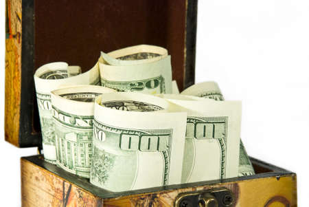 Brown chest full of American dollars isolated on white backgroundの写真素材