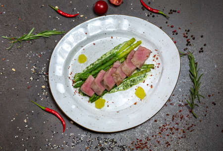 Tuna with asparagus with creamy spinach sauce. Tuna fried with sesame oil, grilled asparagus, cream-based sauce, spinach and cheeseの写真素材