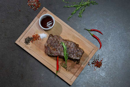 Steak striploin. Marbled grass-fed beef. Served with BBQ sauce. flat layの写真素材
